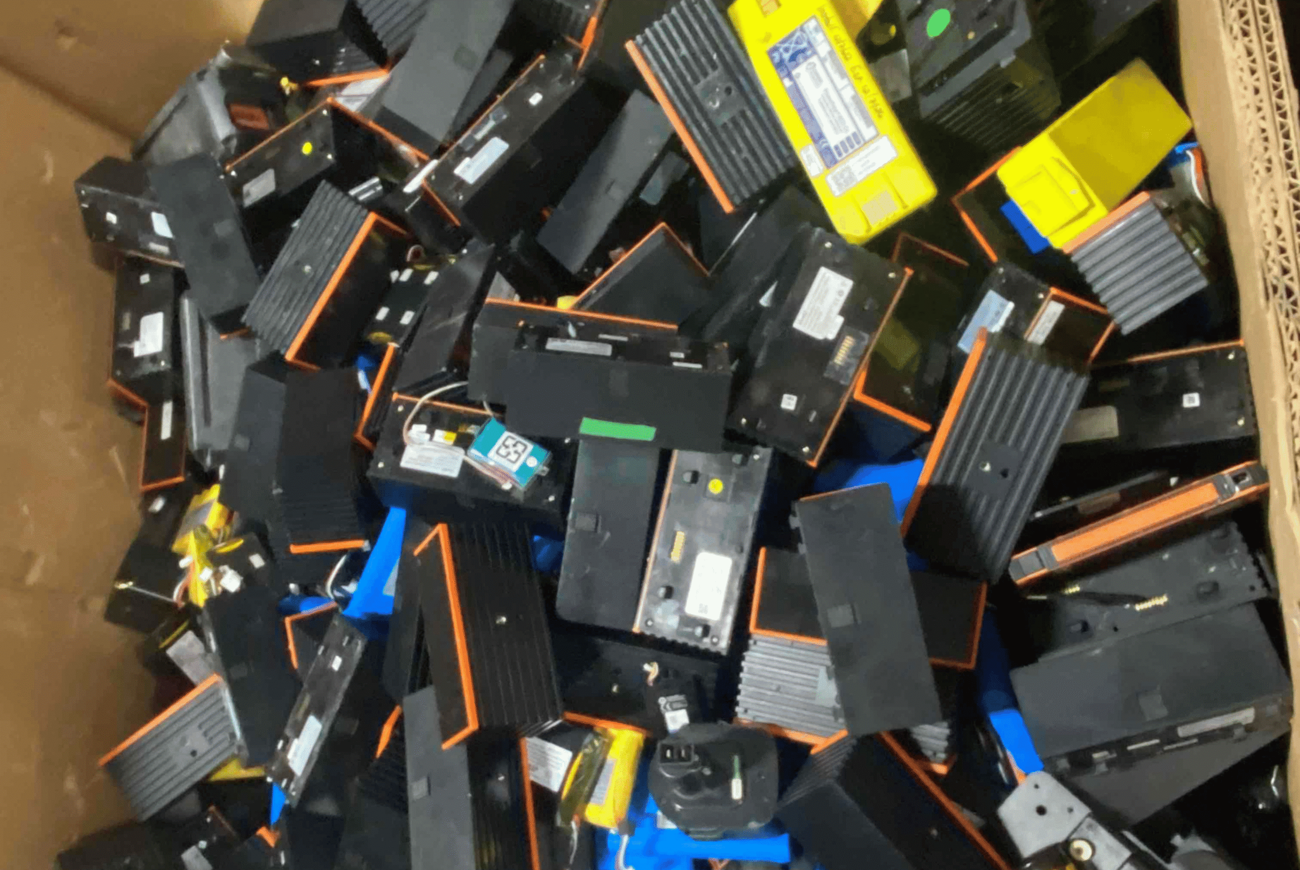 Mixed lithium-ion batteries loosely piled inside of a Gaylord box
